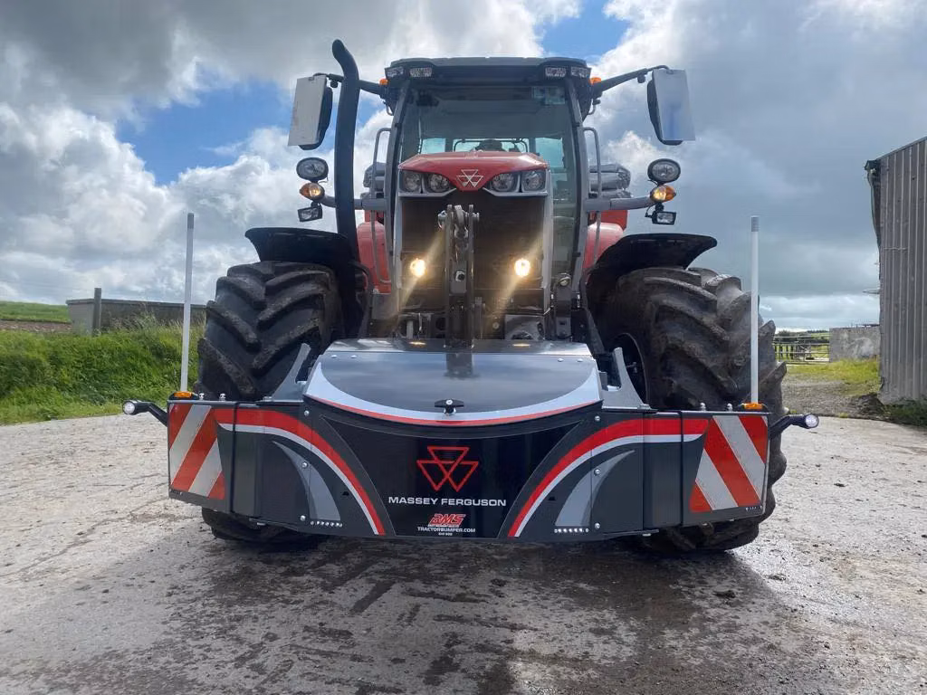 A red tractor fitted with a Massey Ferguson front weight bumper featuring reflective stripes and lights