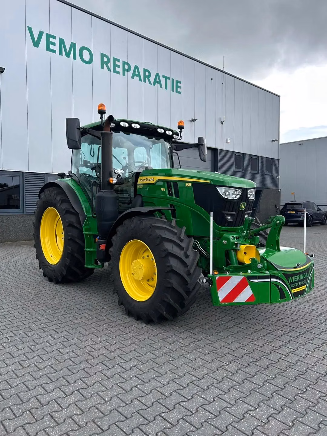 John Deere tractor with a TractorBumper front bumper and rear weight