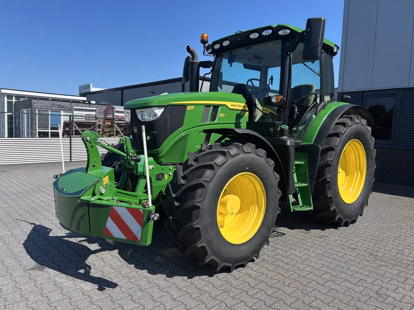 John Deere tractor with a TractorBumper front bumper and rear weight