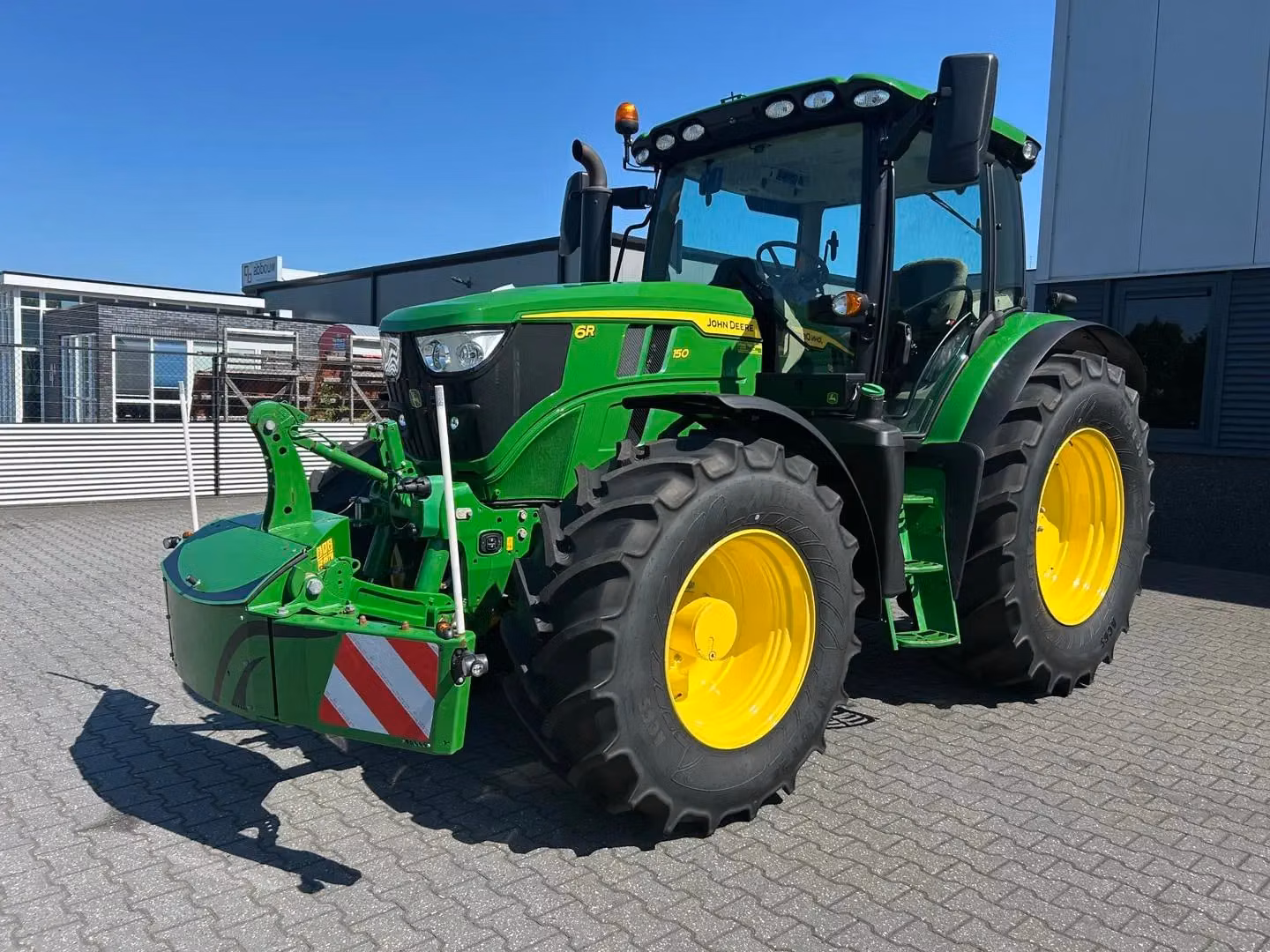 John Deere tractor with a TractorBumper front bumper and rear weight