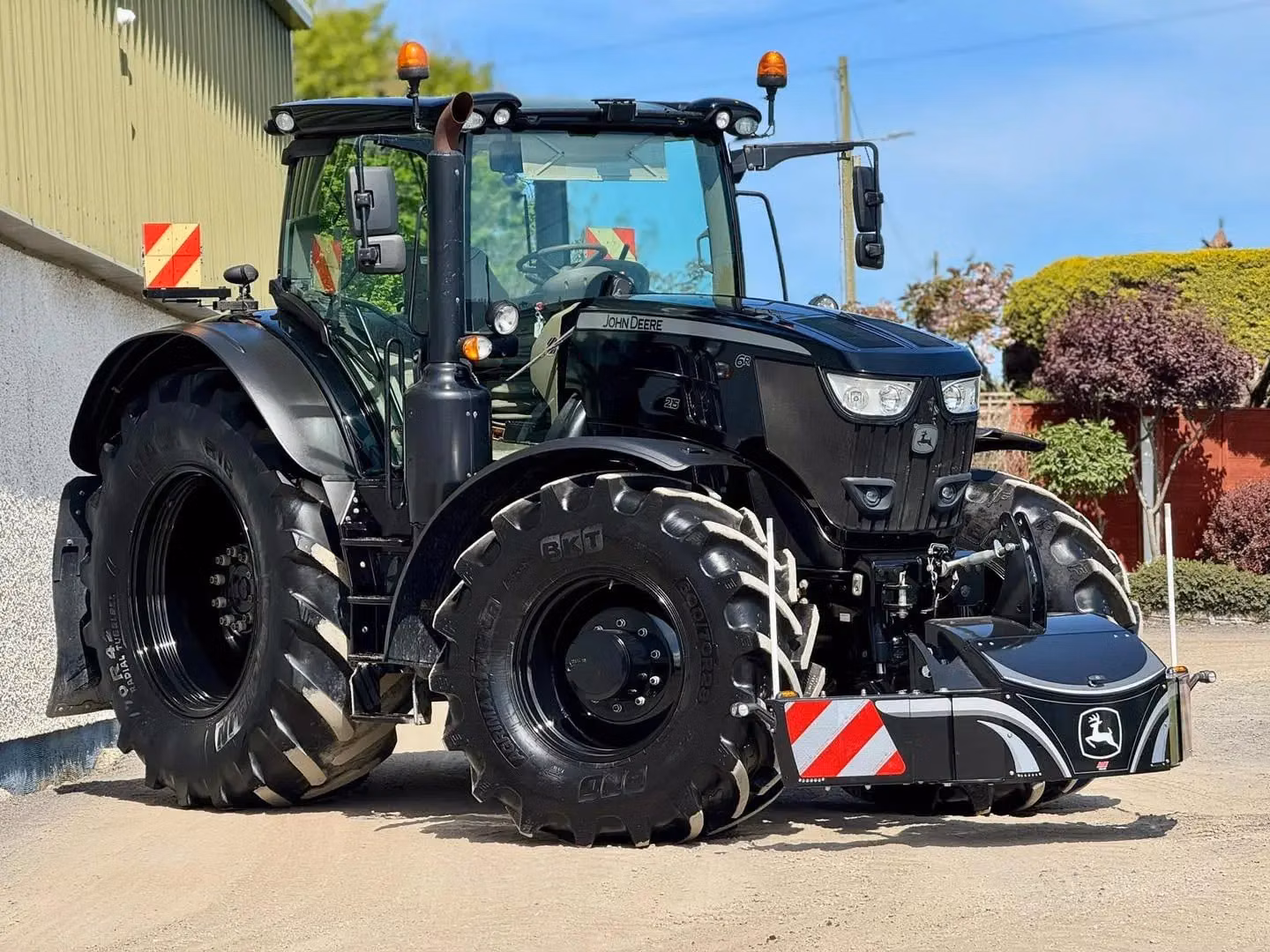 John Deere tractor with a TractorBumper front bumper and rear weight