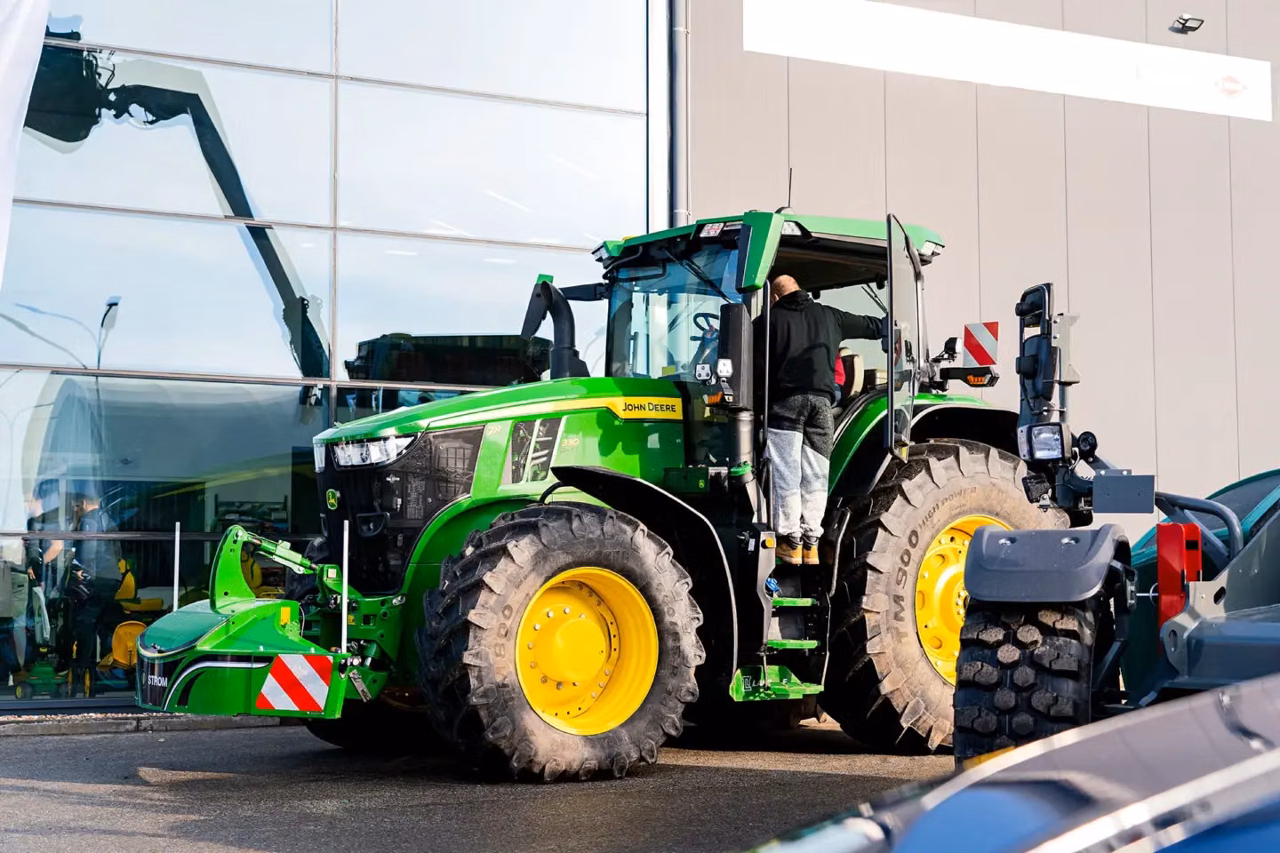 John Deere tractor with a TractorBumper front bumper and rear weight