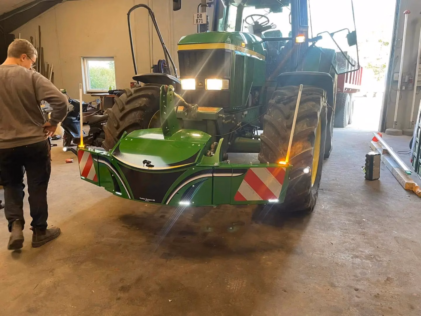 John Deere tractor with a TractorBumper front bumper and rear weight