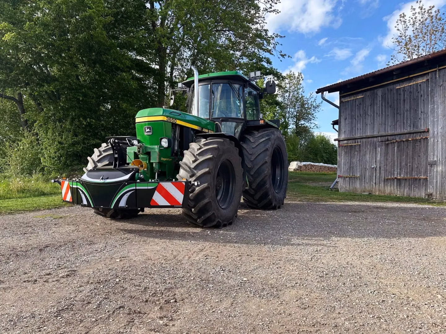 John Deere tractor with a TractorBumper front weight and LED lighting