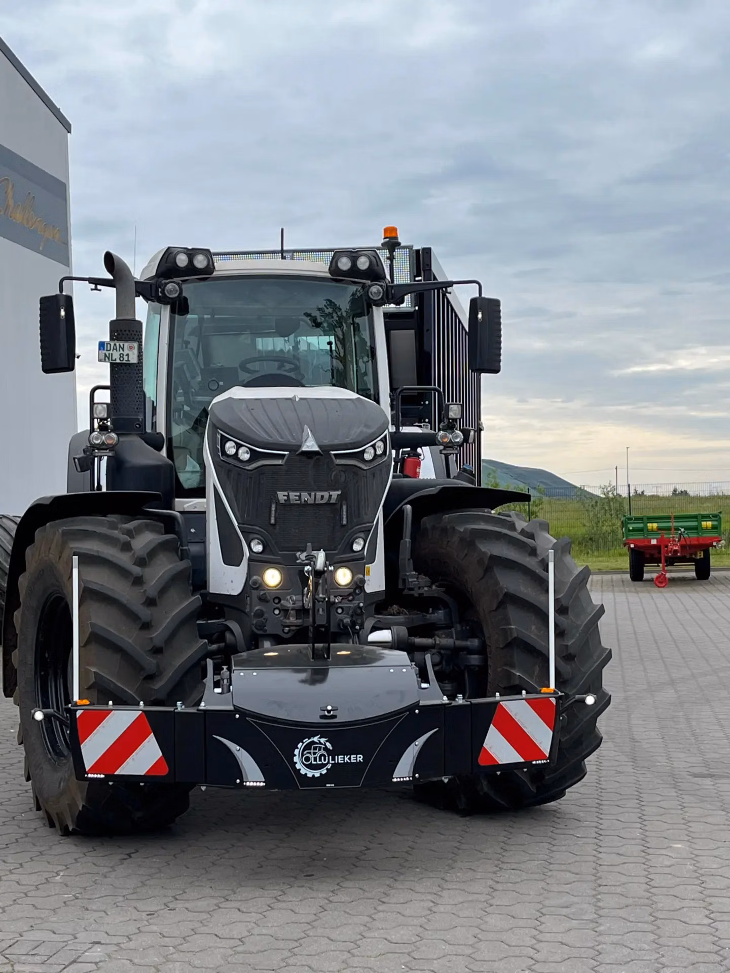 Front view of a tractor with a mounted front weight bumper featuring safety reflectors, lights and a GOLIEKER logo