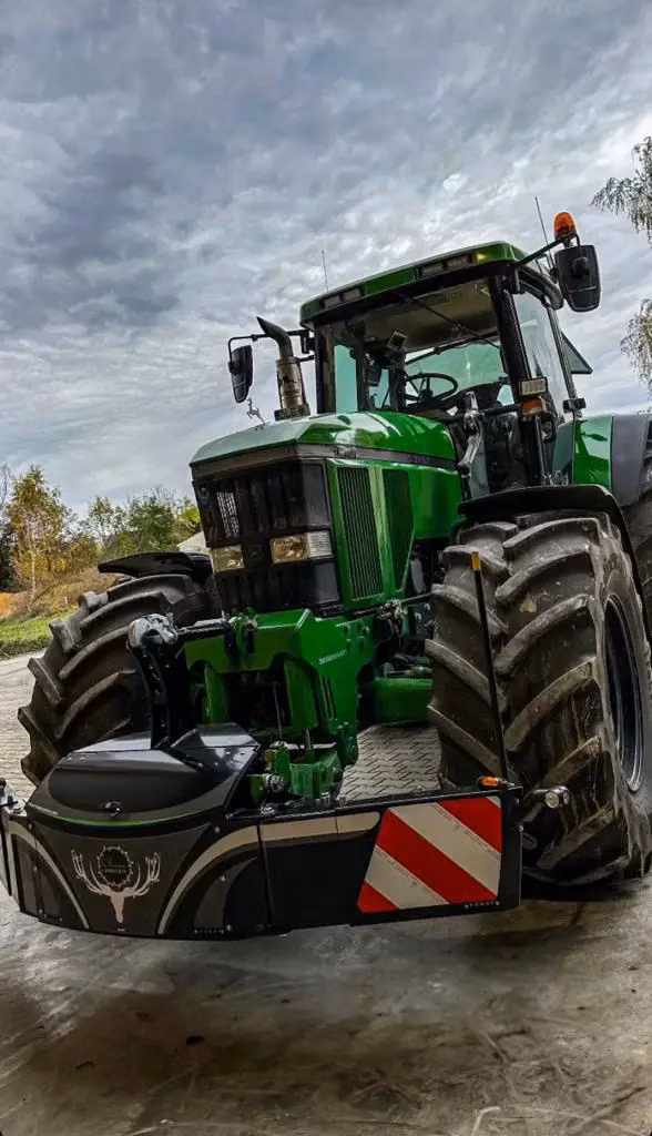 John Deere tractor with a TractorBumper front weight and LED lighting