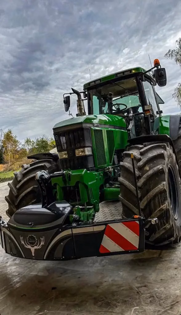 John Deere tractor with a TractorBumper front weight and LED lighting