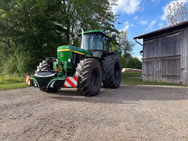 John Deere tractor with a TractorBumper front bumper and rear weight
