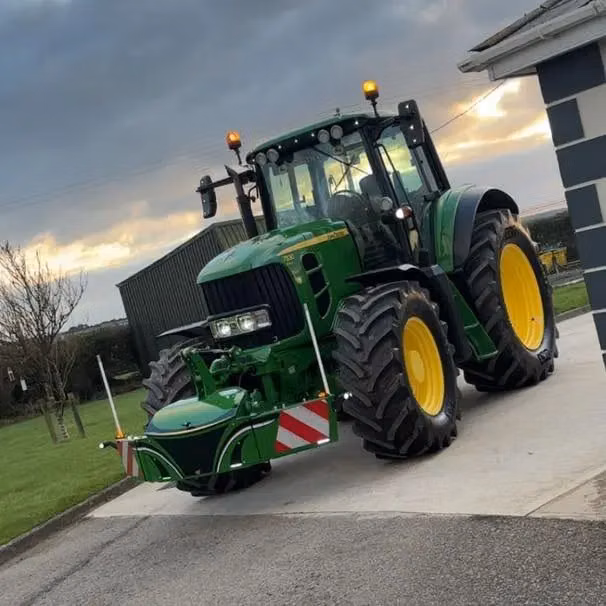 John Deere tractor with a TractorBumper front bumper and rear weight