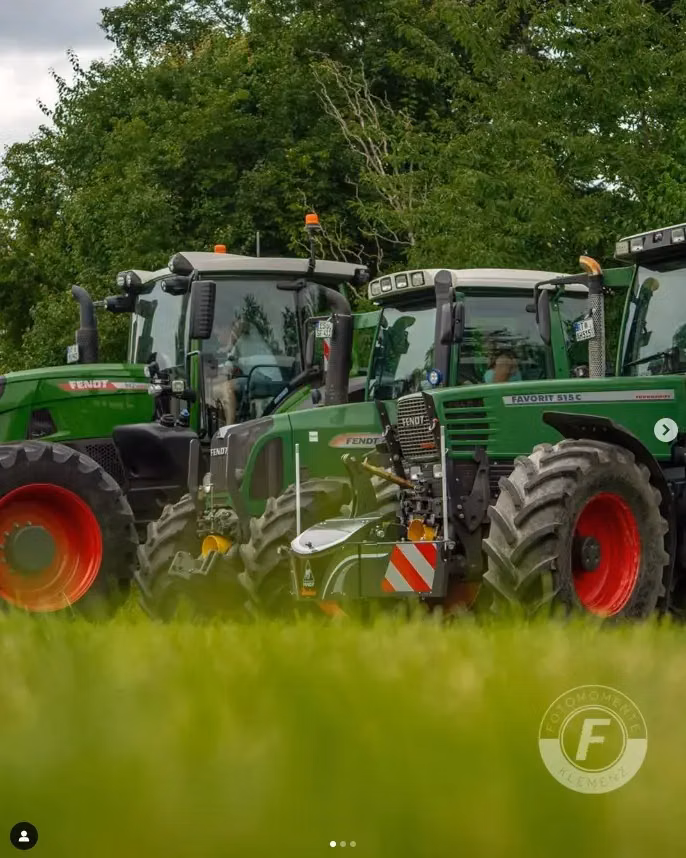 Three green tractors with front weight bumpers and LED lighting are parked on grass with trees in the background