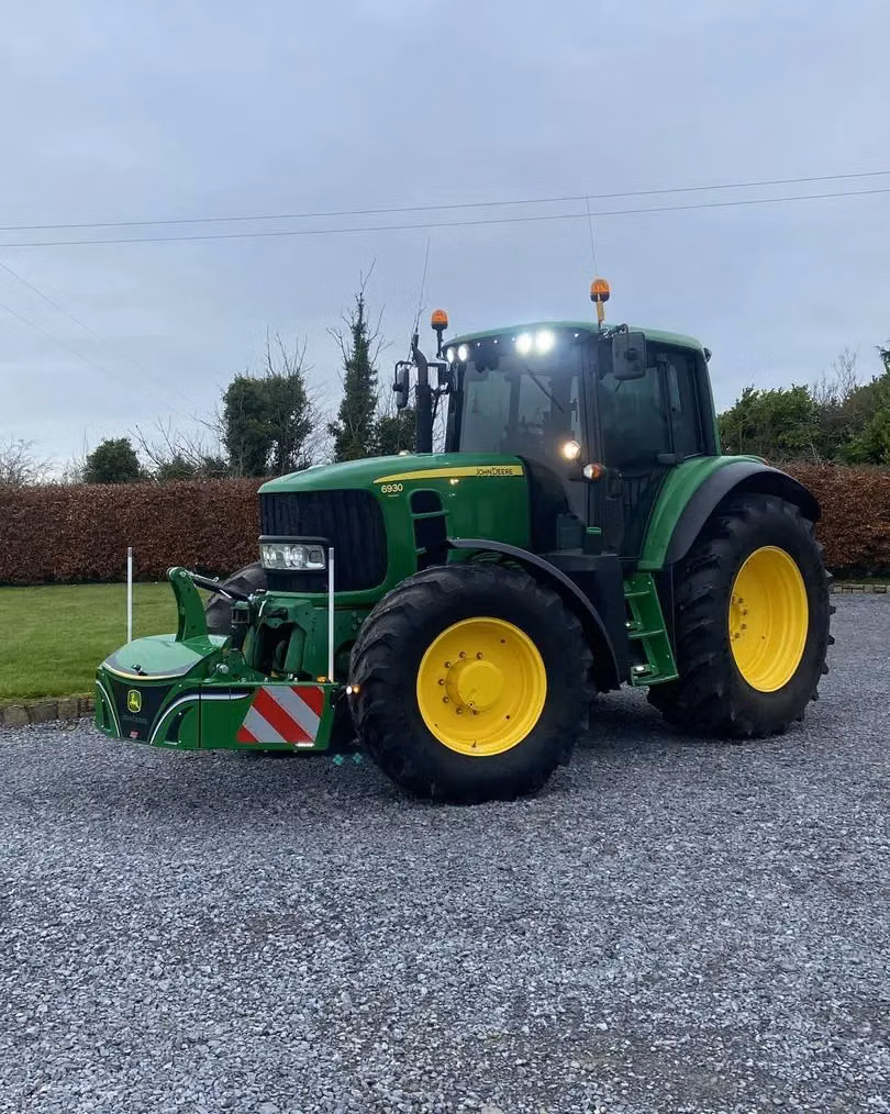 John Deere tractor with a TractorBumper front bumper and rear weight